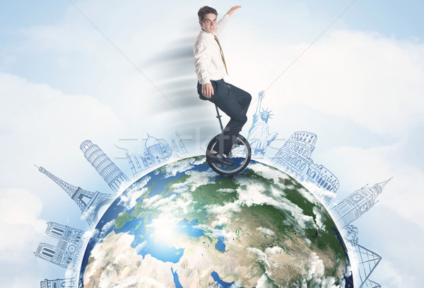 Man riding unicycle around the globe with major cities Stock photo © ra2studio
