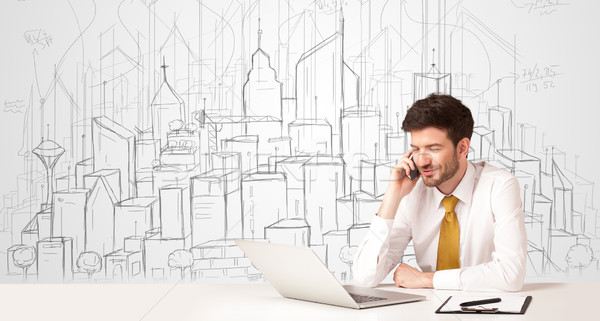 Businessman sitting at the white table with hand drawn buildings Stock photo © ra2studio