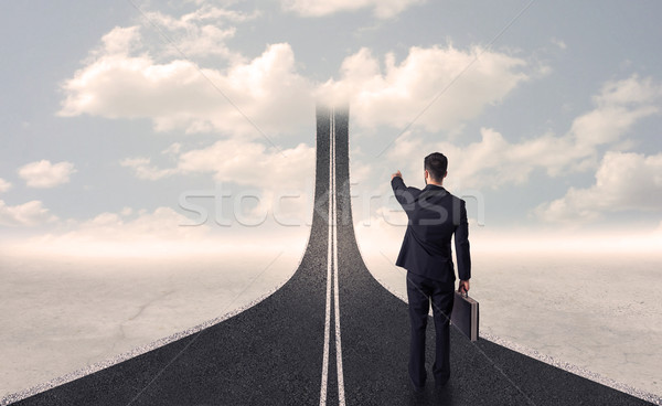 Businessman looking at 3d road that goes up in the sky Stock photo © ra2studio