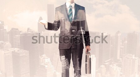 Handsome business man with overlay cityscape Stock photo © ra2studio