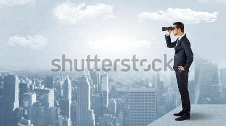 Stock photo: Man looking forward from the top of a skyscraper