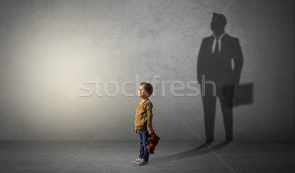 Little boy with businessman shadow Stock photo © ra2studio