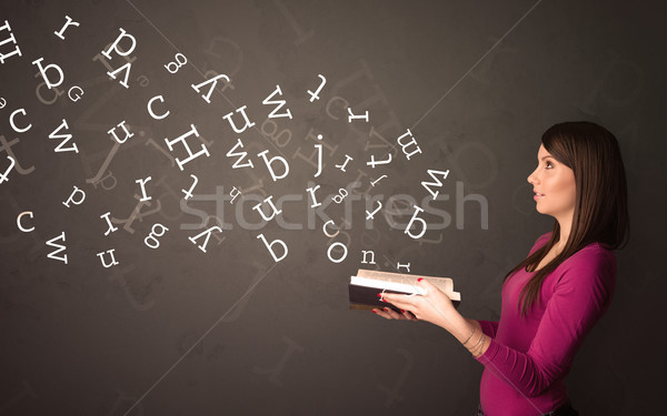 Young lady holding book with letters Stock photo © ra2studio