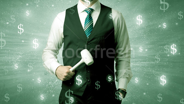 Businassman standing with tool on his hand. Stock photo © ra2studio