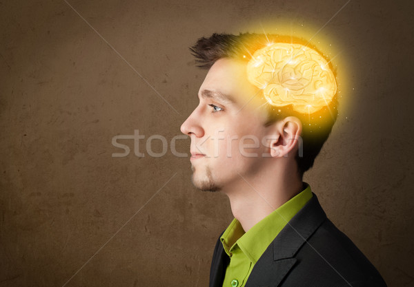 Young man thinking with glowing brain illustration Stock photo © ra2studio