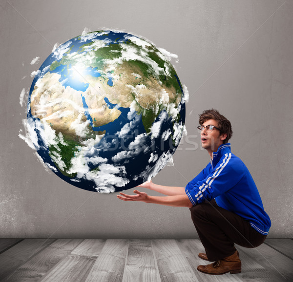 Good-looking man holding 3d planet earth Stock photo © ra2studio