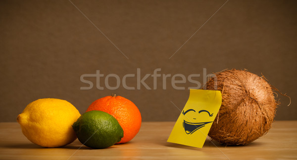 Coconut with post-it note laughing on citrus fruits Stock photo © ra2studio