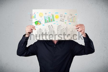 Businessman holding a paper with charts and cityscape in front o Stock photo © ra2studio