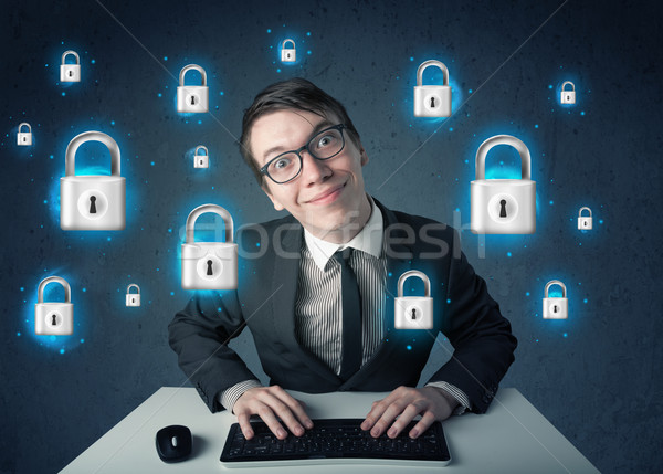 Young hacker with virtual lock symbols and icons Stock photo © ra2studio