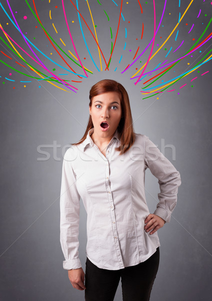 Young girl thinking with colorful abstract lines overhead Stock photo © ra2studio