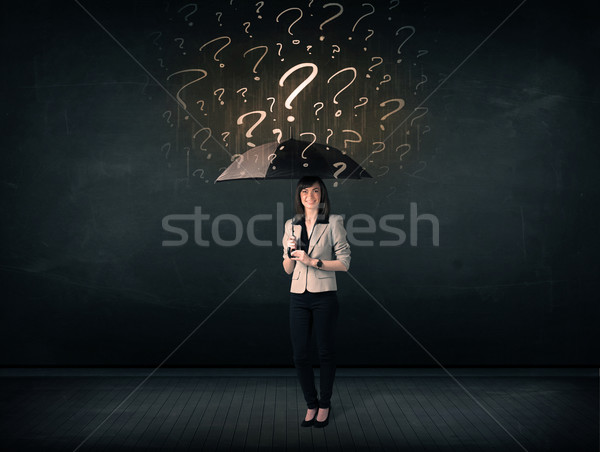 Businesswoman with umbrella and a lot of drawn question marks Stock photo © ra2studio