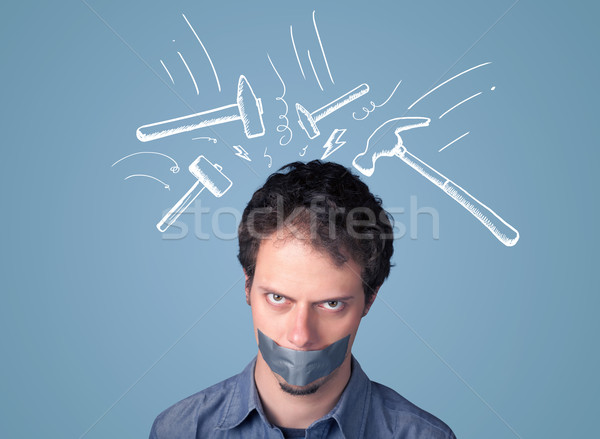Young man with glued mouth and beating hammer marks Stock photo © ra2studio