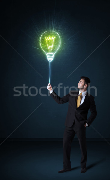 Businessman with an idea bulb Stock photo © ra2studio