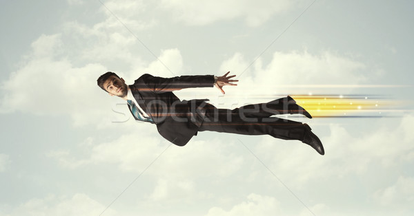 Happy business man flying fast on the sky between clouds Stock photo © ra2studio