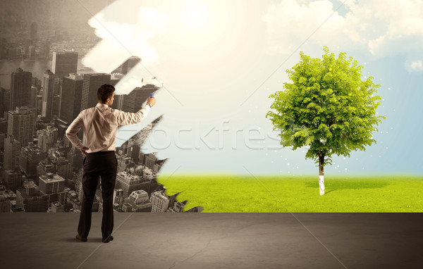 Salesman painting tree instead of city Stock photo © ra2studio