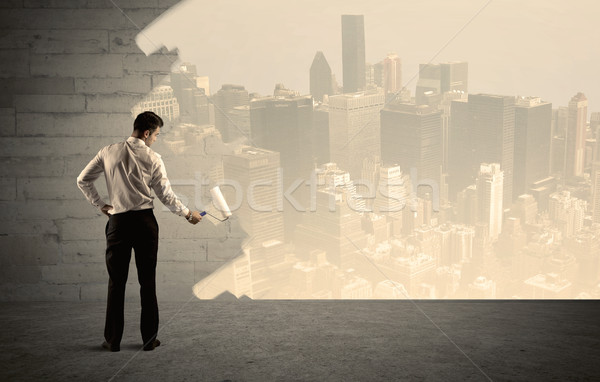 Salesman painting city scape on wall Stock photo © ra2studio