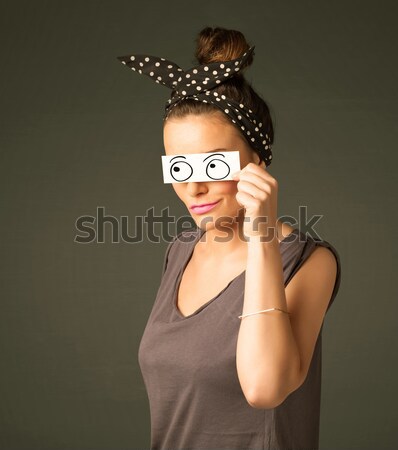 Young silly girl looking with hand drawn eye balls on paper Stock photo © ra2studio