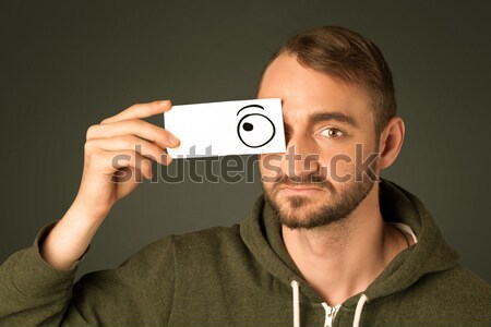 Funny man looking with hand drawn paper eyes Stock photo © ra2studio