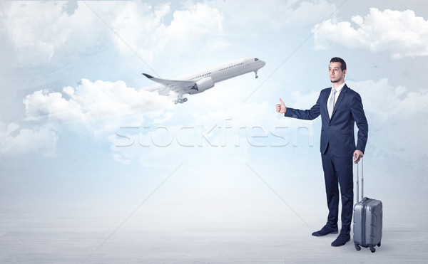 Agent hitchhiking with departing plane concept Stock photo © ra2studio
