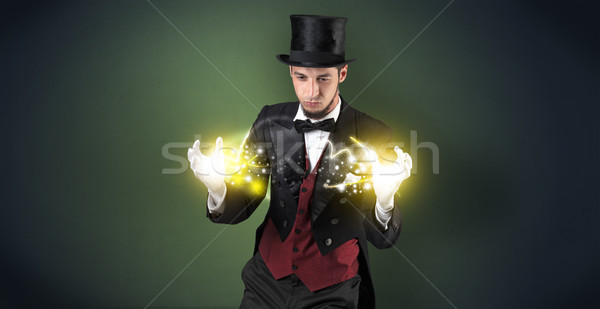 Magician holding his power on his hand Stock photo © ra2studio