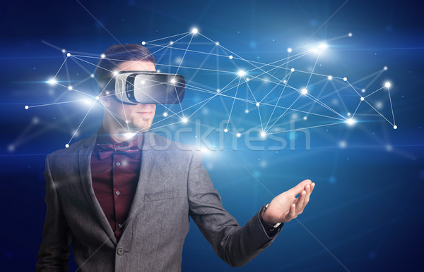 Businessman with virtual reality goggles Stock photo © ra2studio