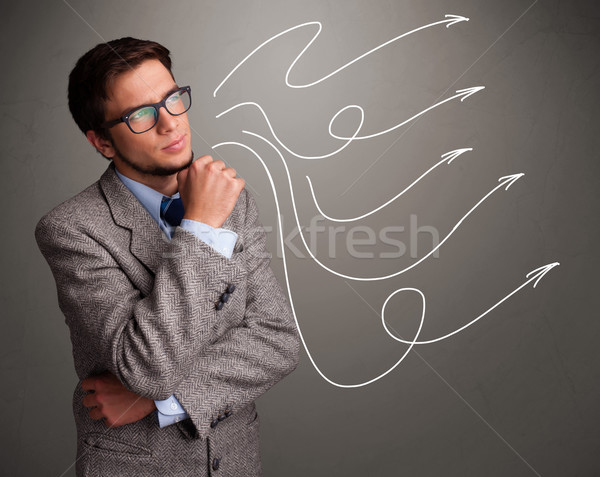 Attractive man looking at multiple curly arrows Stock photo © ra2studio