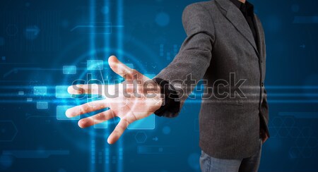 Businessman pressing imaginary button Stock photo © ra2studio