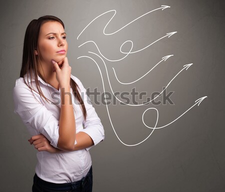 Attractive teenager looking at multiple curly arrows Stock photo © ra2studio