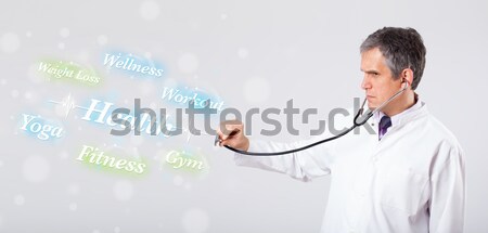 Stock photo: Clinical doctor pointing to health and fitness collection of wor