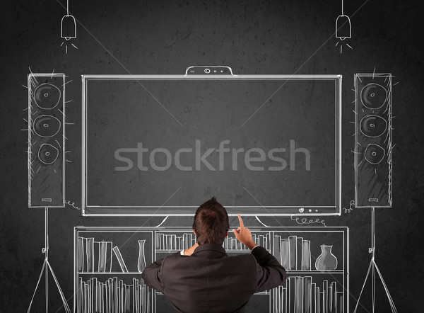 Businessman in front of a home cinema system Stock photo © ra2studio