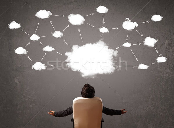 Businessman sitting with cloud technology above his head Stock photo © ra2studio