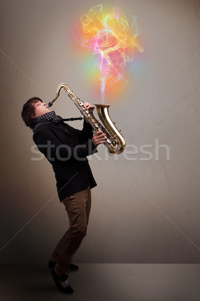 Attractive musician playing on saxophone with colorful abstract  Stock photo © ra2studio