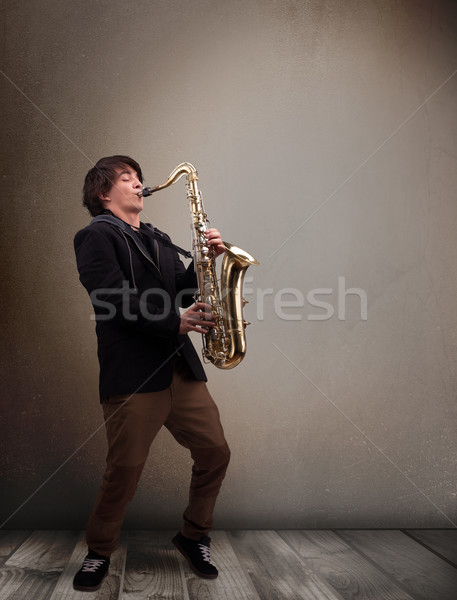 Young musician playing on saxophone Stock photo © ra2studio