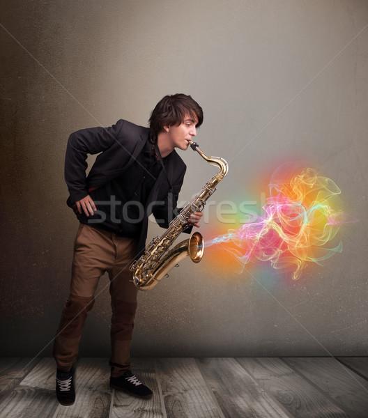 Attractive musician playing on saxophone with colorful abstract  Stock photo © ra2studio