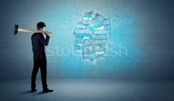 Business man hitting brick wall with huge hammer Stock photo © ra2studio