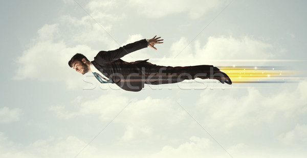 Happy business man flying fast on the sky between clouds Stock photo © ra2studio