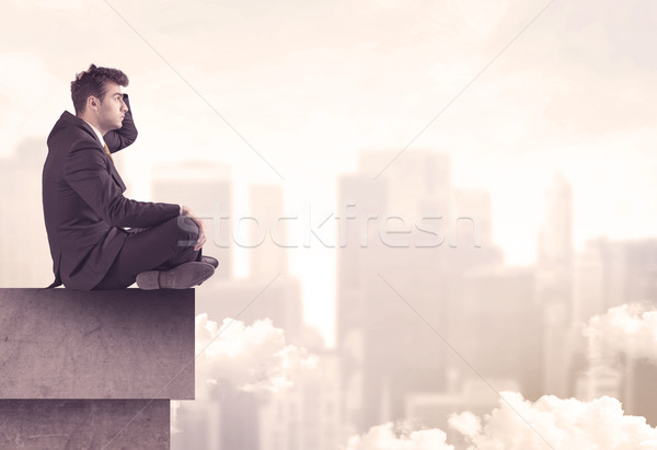 Peaceful sales guy sitting on roof top Stock photo © ra2studio