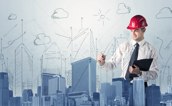 Stock photo: Young worker drawing a city sight