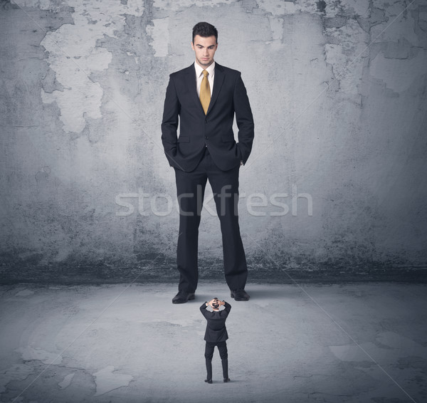 Big business bully looking at small coworker Stock photo © ra2studio