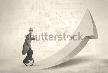 Happy business man riding a monocycle up on an arrow  Stock photo © ra2studio