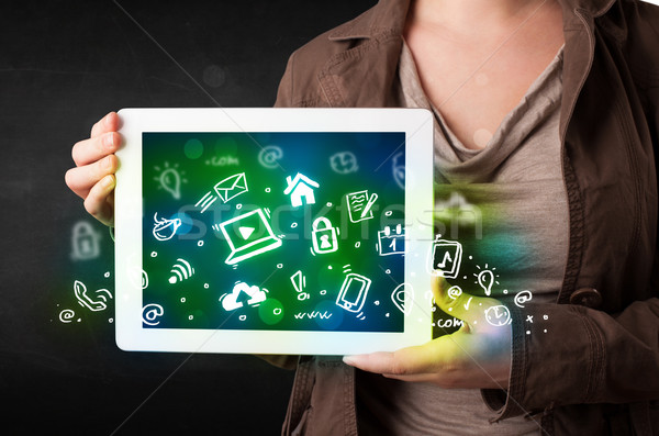 Person holding tablet with green media icons and symbols Stock photo © ra2studio