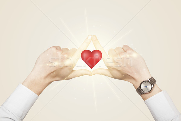 Hands creating a form with shining heart Stock photo © ra2studio