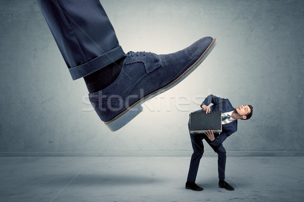 Employee getting trampled by big shoe Stock photo © ra2studio