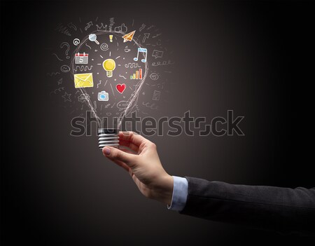 Stock photo: Woman drawing light bulb on whiteboard