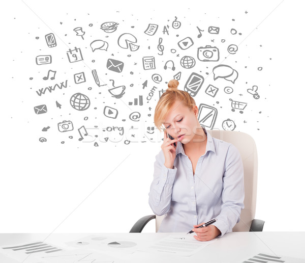 Beautiful young businesswoman with all kind of hand-drawn media icons in background Stock photo © ra2studio