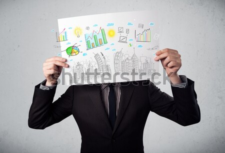 Businessman holding a paper with charts and cityscape in front o Stock photo © ra2studio