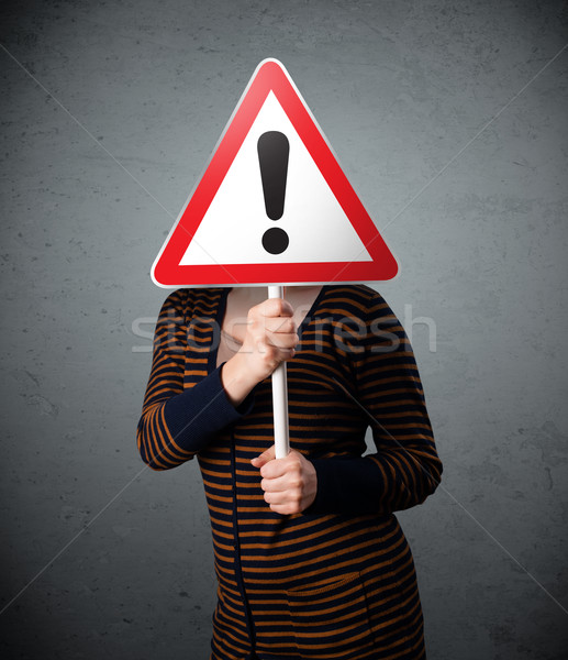 Young woman holding an exclamation road sign Stock photo © ra2studio