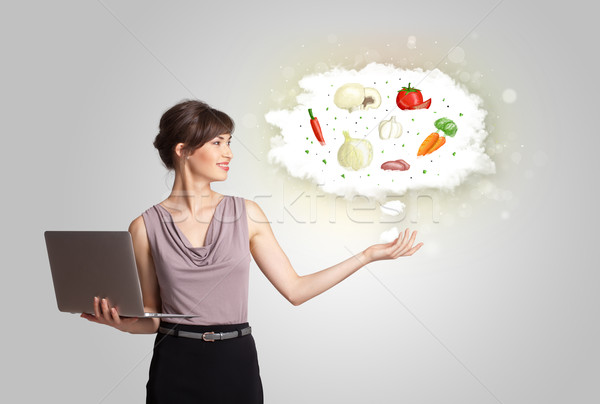 Stock photo: Pretty woman presenting a cloud of healthy nutritional vegetable