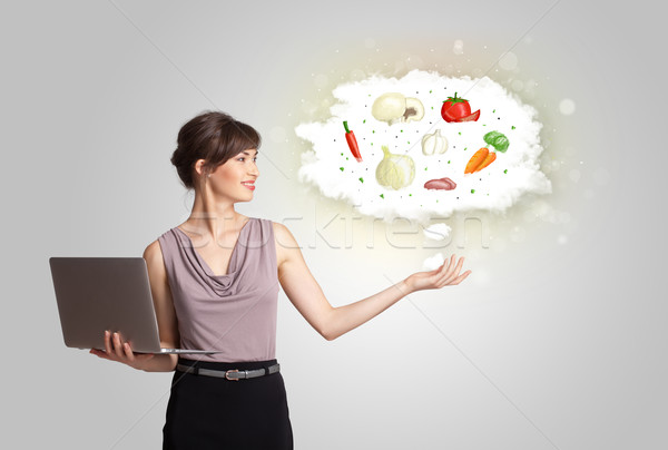 Pretty woman presenting a cloud of healthy nutritional vegetable Stock photo © ra2studio