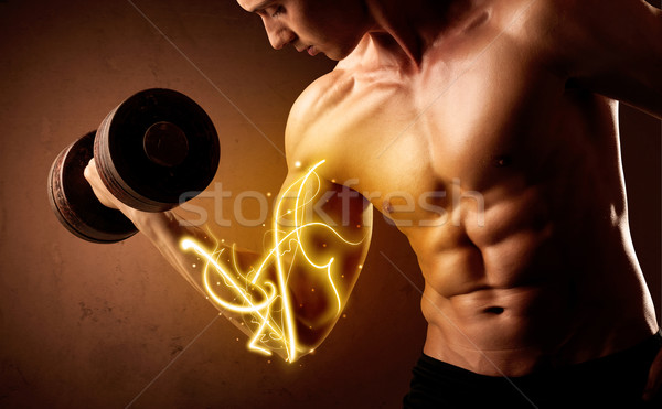 Muscular body builder lifting weight with energy lights on bicep Stock photo © ra2studio